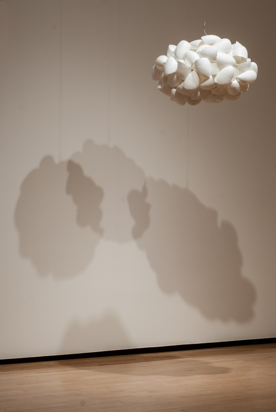 Image of suspended "Cloud" sculpture created from cast urethane and stainless steel