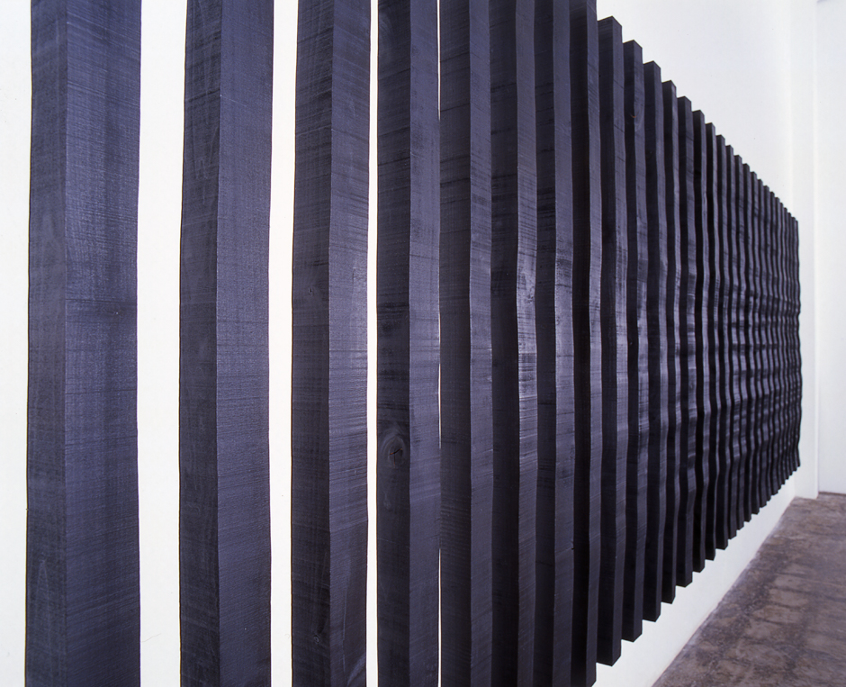 Detail image of wall mounted "Replication II" sculpture created from wood bandsawn and burnished with graphite