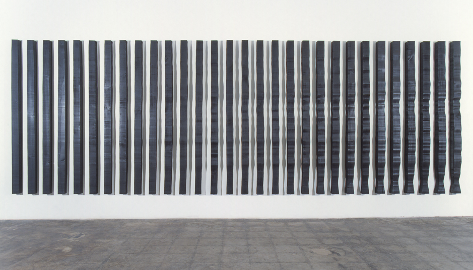 Image of wall mounted "Replication II" sculpture created from wood bandsawn and burnished with graphite